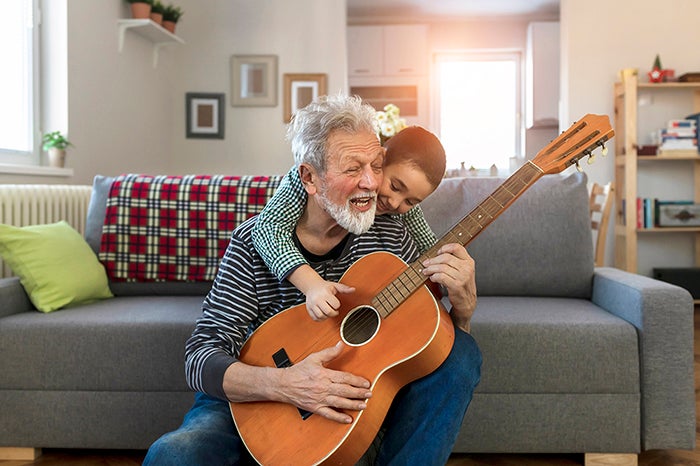 Grandpa playing guitar with grandson