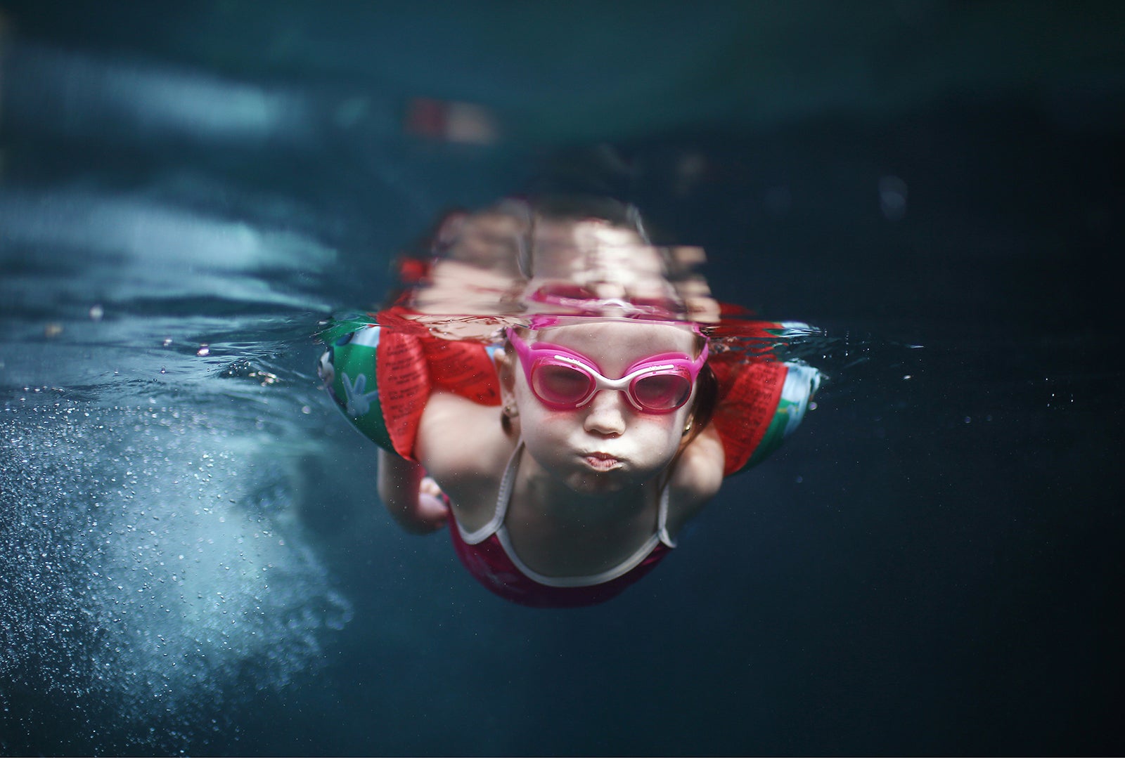 A 4 years old girl swimming under water