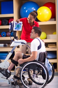 healthcare worker helping patient in wheel chair