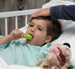 Child eating popsicle in hospital bed