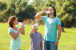 family drinking bottled water