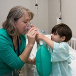 child interacting with nurse