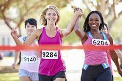 women running across a finish line
