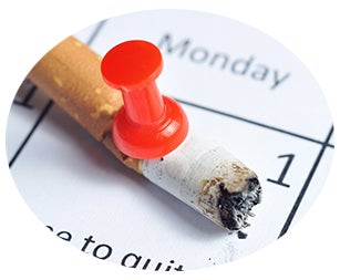 cigarrette on calender with pin in it to stop smoking