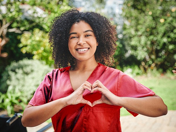 Nurse making a heart symbol with her hands