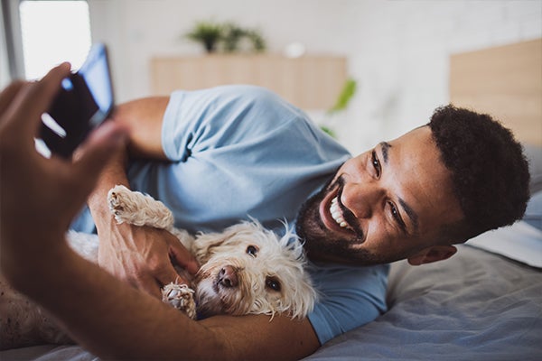 Man laying on bed with their dog