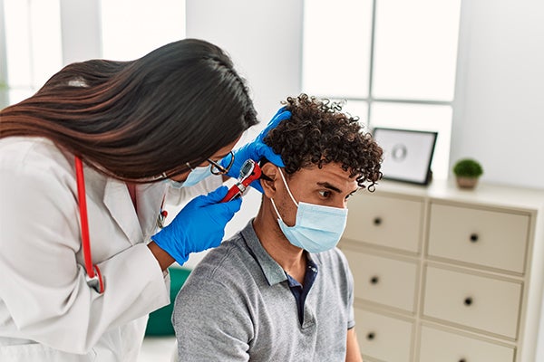 Doctor checking on patient's ear