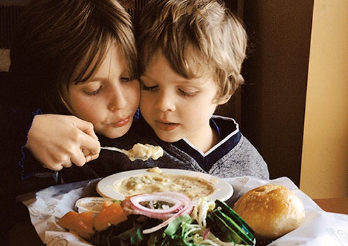 brother and sister eating soup
