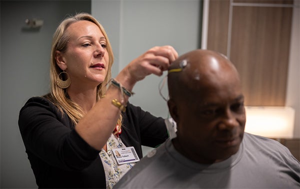 man with sleep apnea getting probes on head