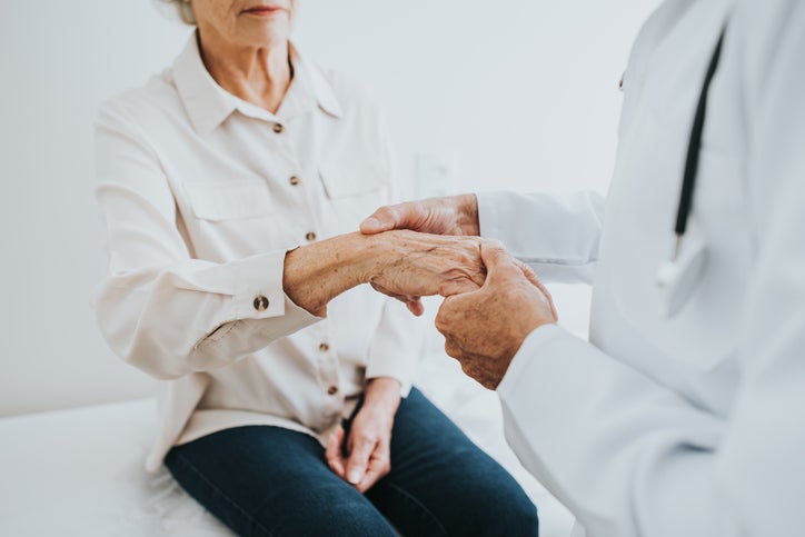 doctor looking at arthritic hand