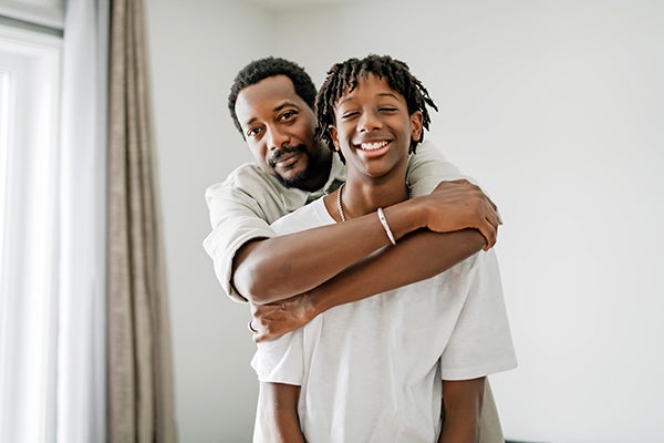 dad hugging teen son