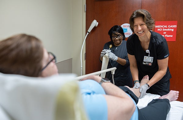 pt smiling while putting on bandage