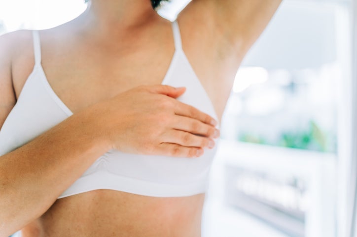 woman touching her breast