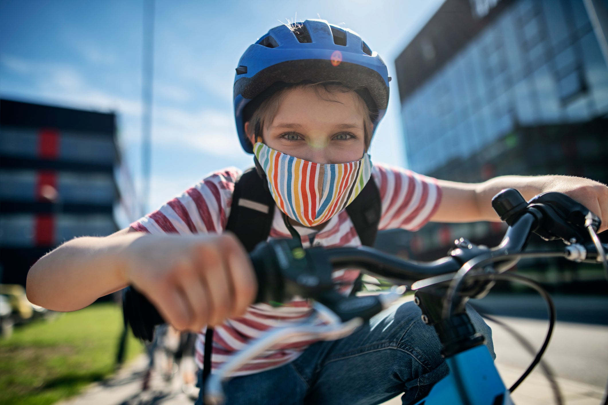 Little boy riding to school during COVID-19 pandemic