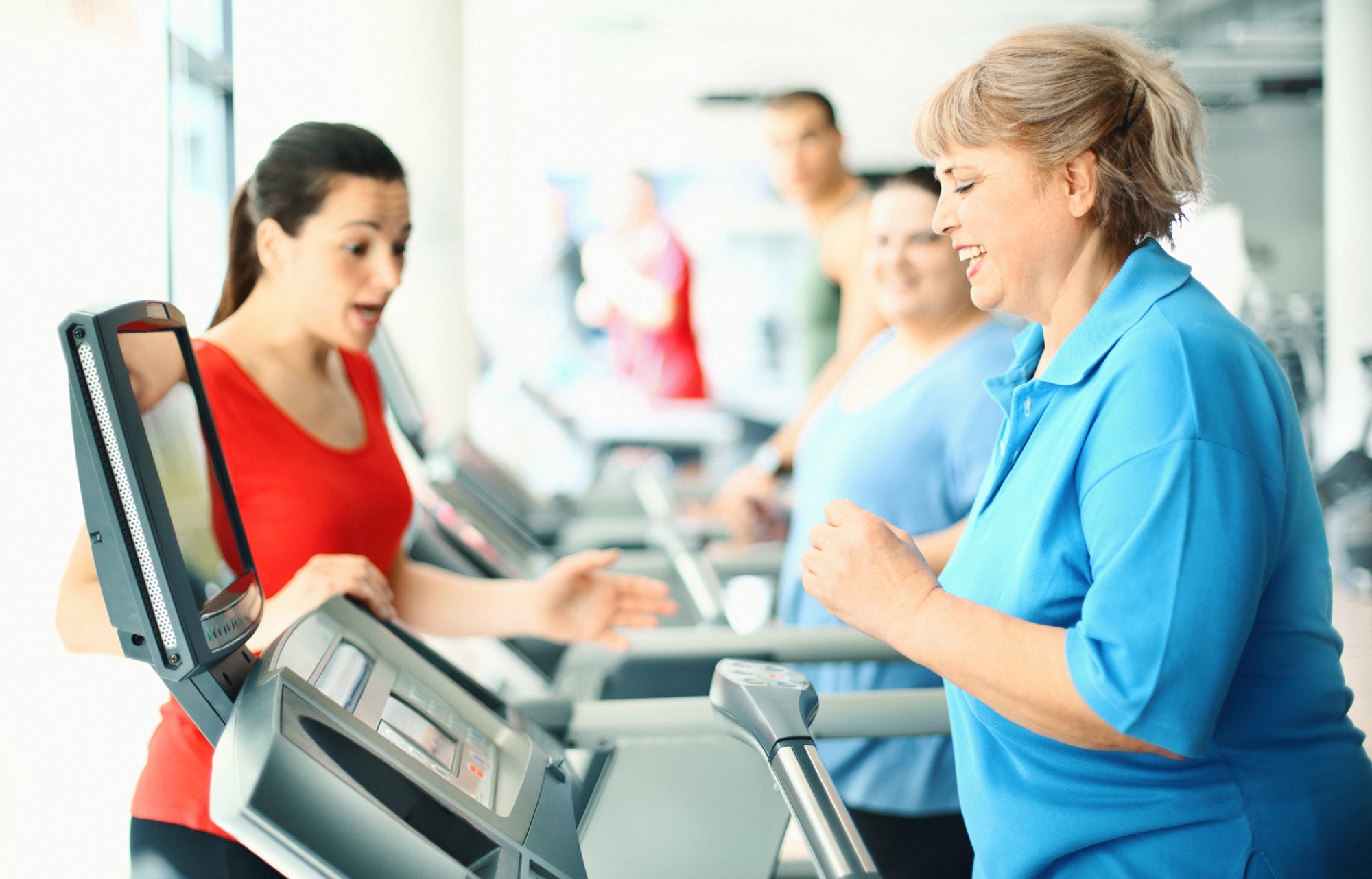 Overweight women exercising on a treadmill.