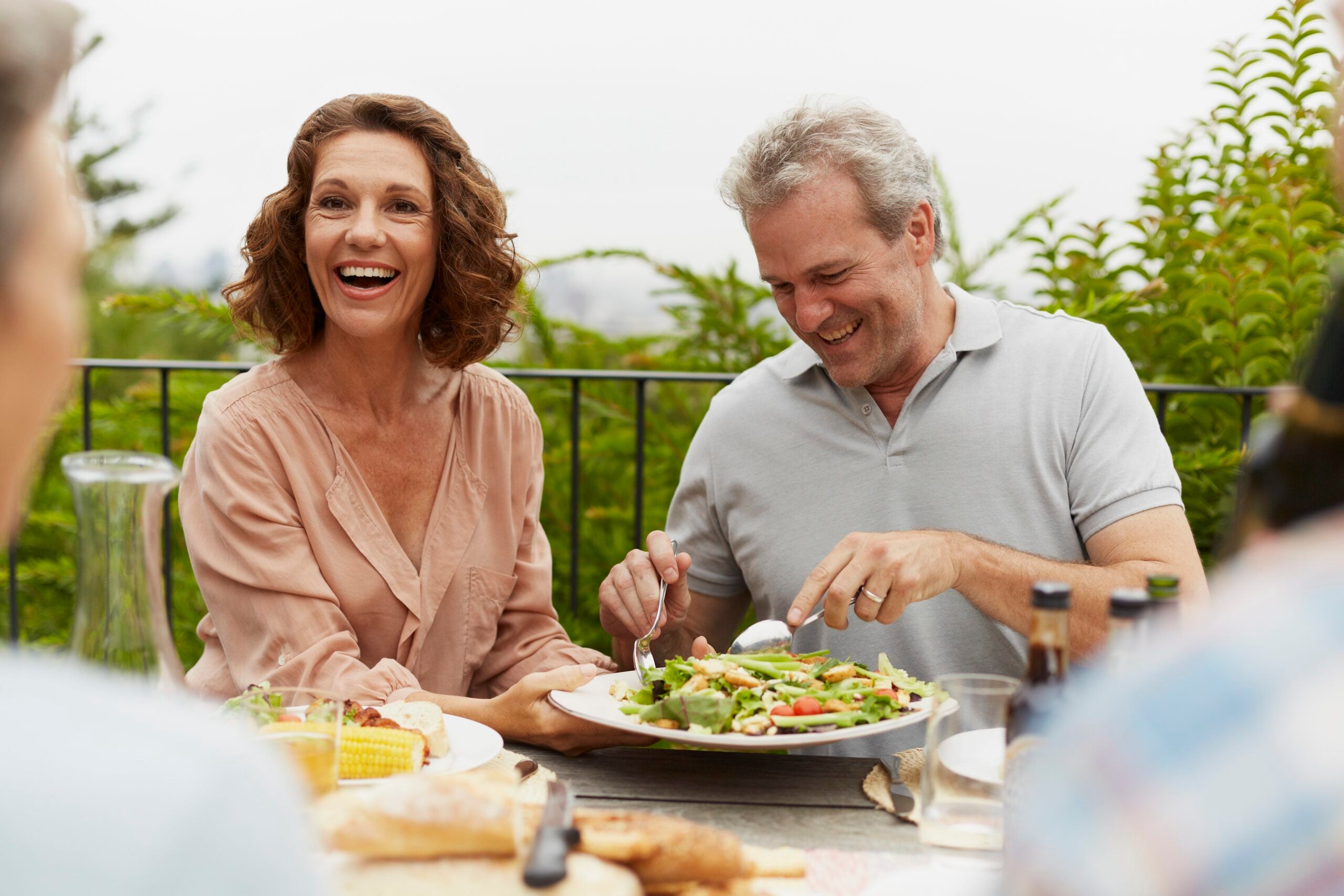 Couple enjoying outdoor lunch with friends