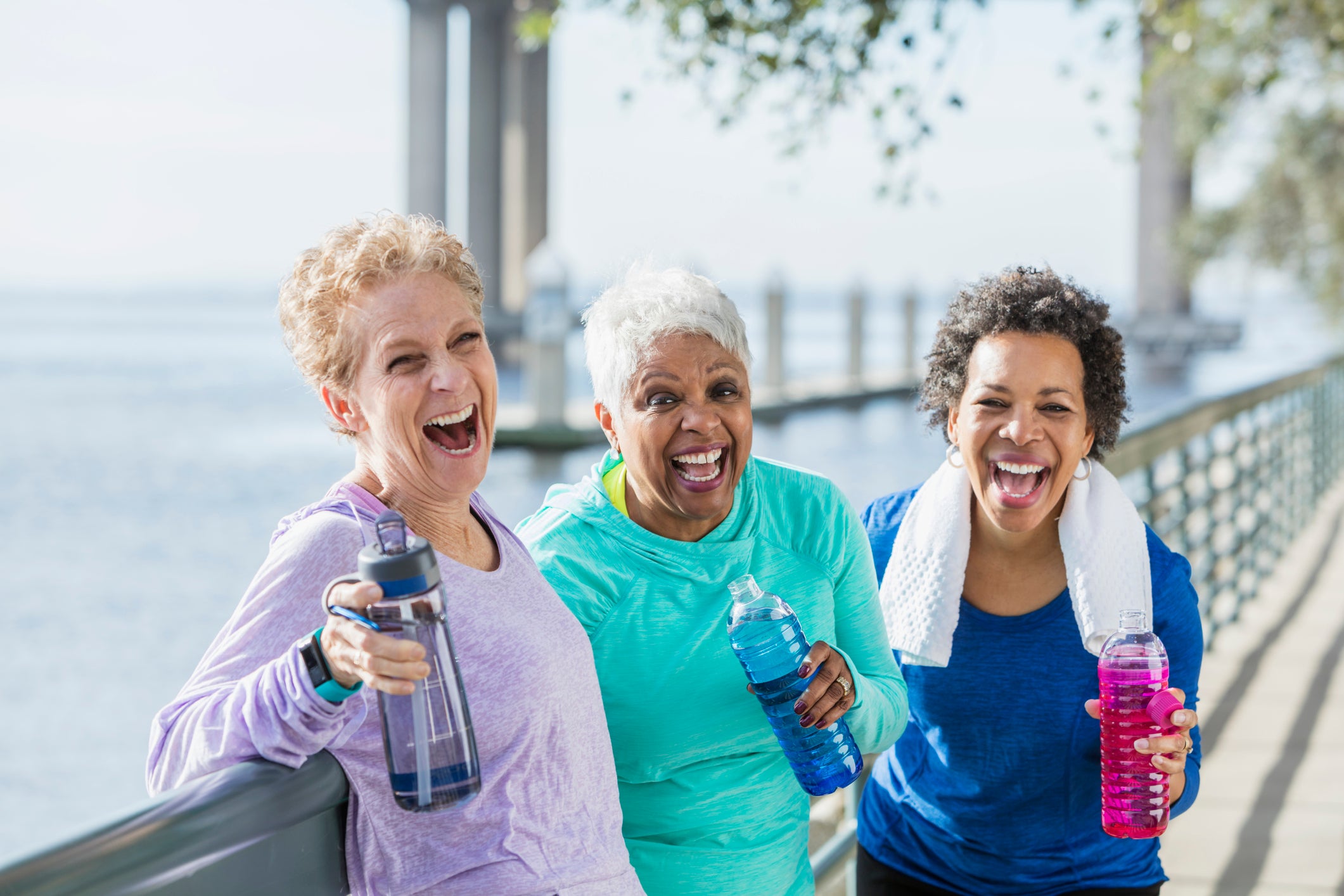Three mature and senior women exercising on waterfront