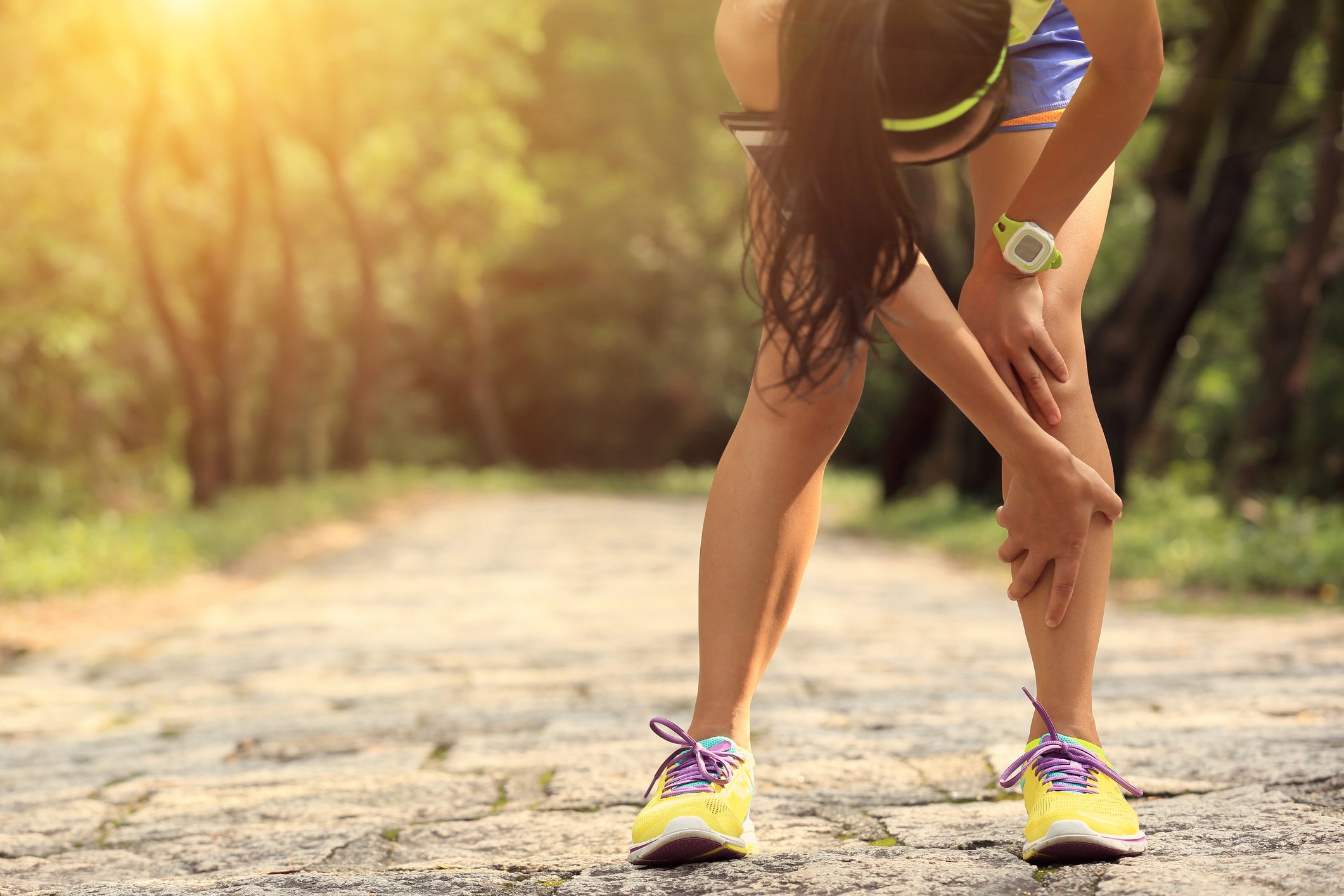 woman runner hold her sports injured knee