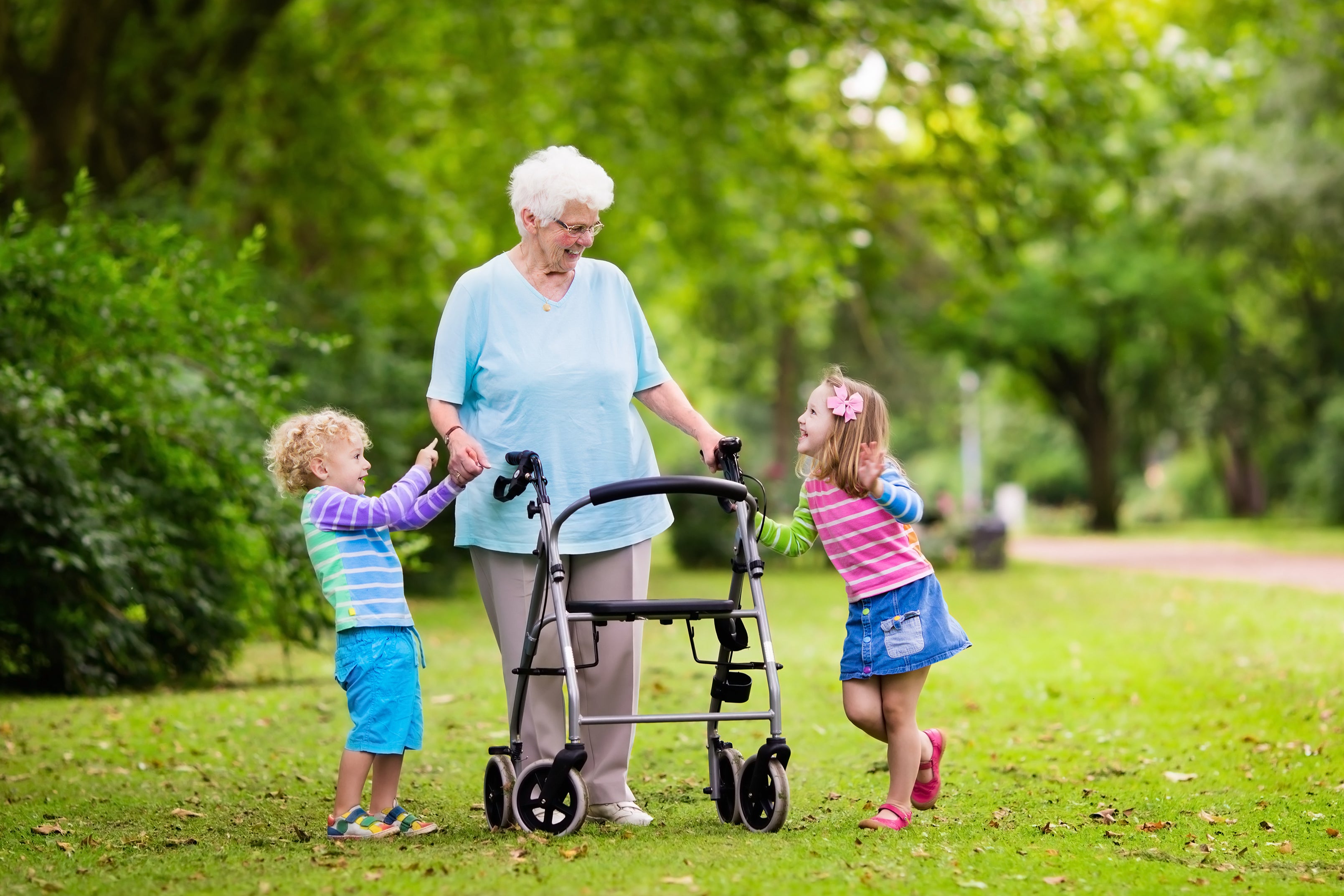 Happy grandmother with walker playing with two kids