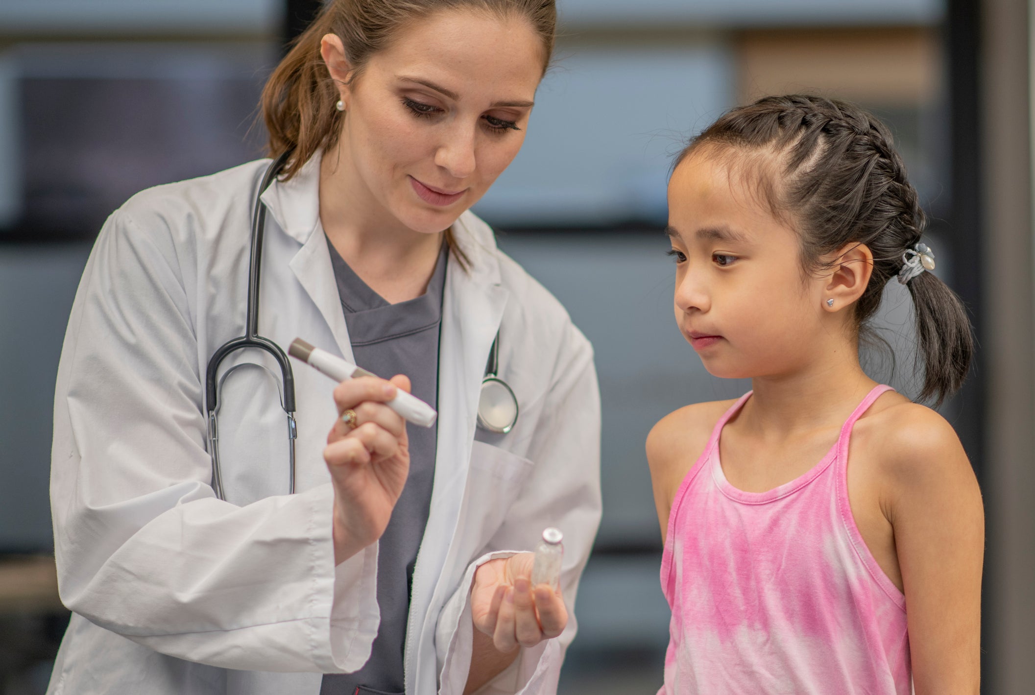 Doctor Educating a Young Girl About Her Diabetes stock photo
