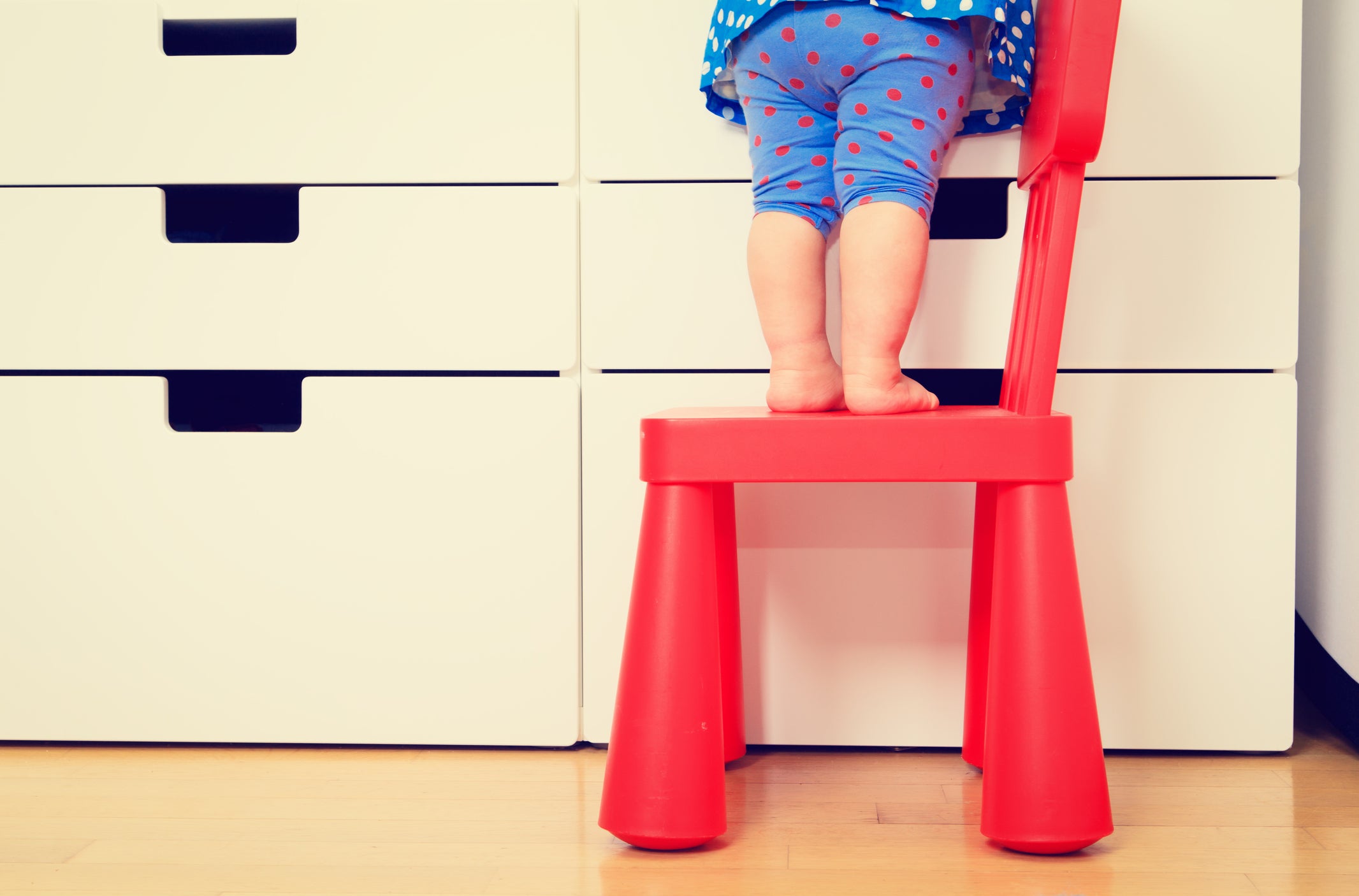 kids safety concept- little girl climb on chair