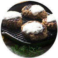 lamb patties on a cast iron pan