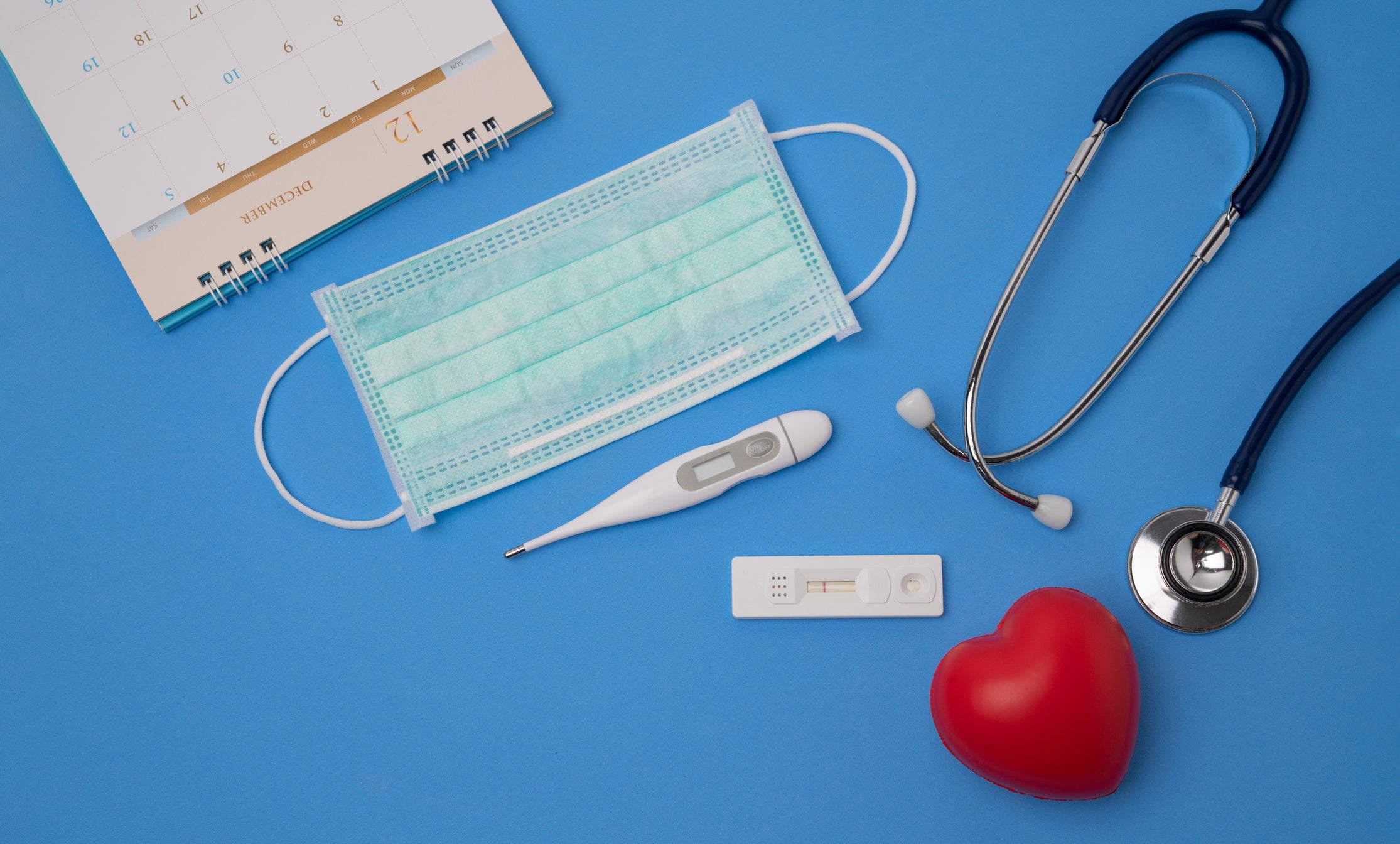 Stethoscope and a calendar. Doctor&rsquo;s appointment and service in the hospital. Coronavirus outbreak. Negative test result by using rapid test device for COVID-19, novel coronavirus 2019 found in Wuhan, China