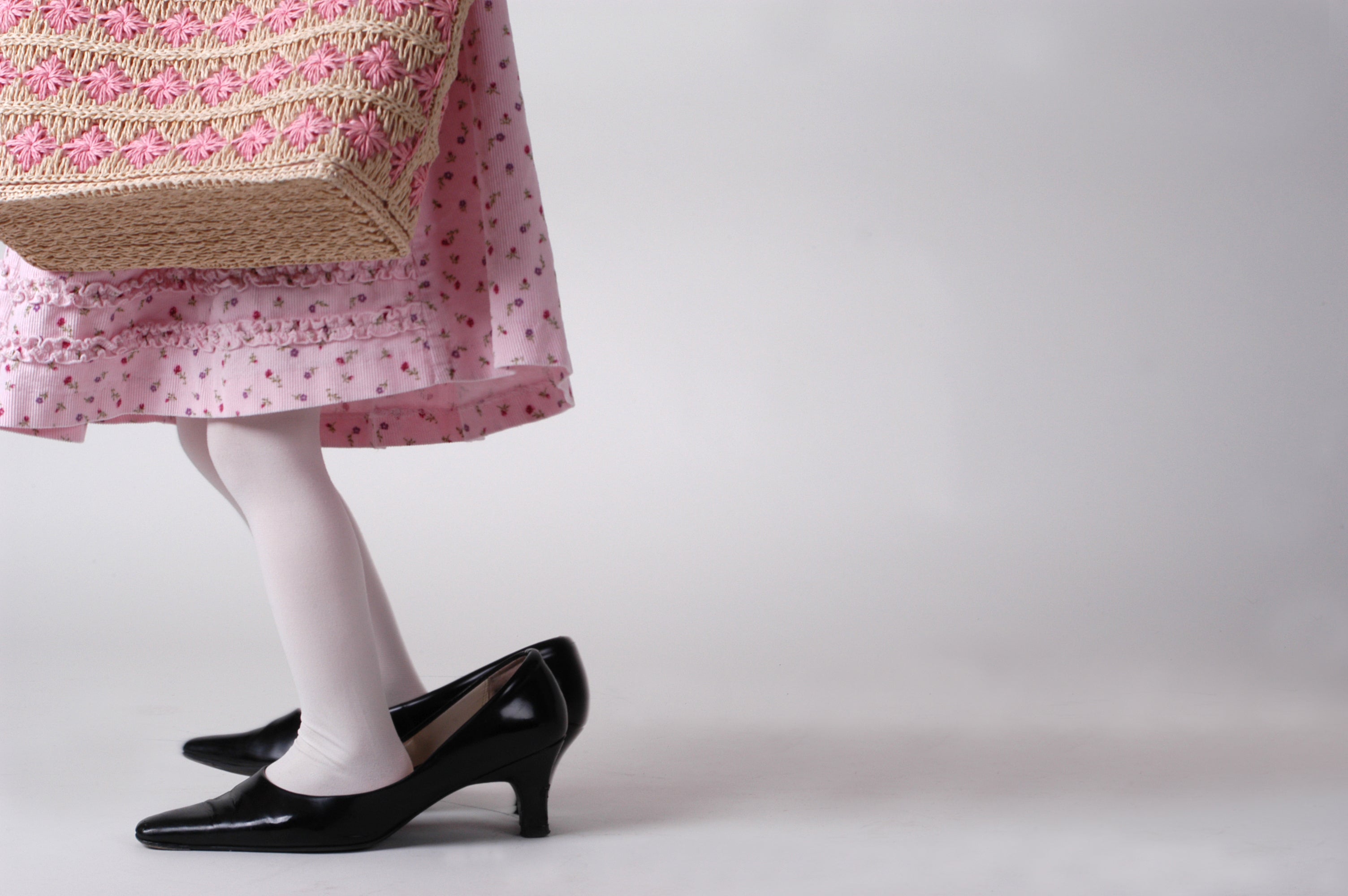 Young girl playing dress up with adult clothes