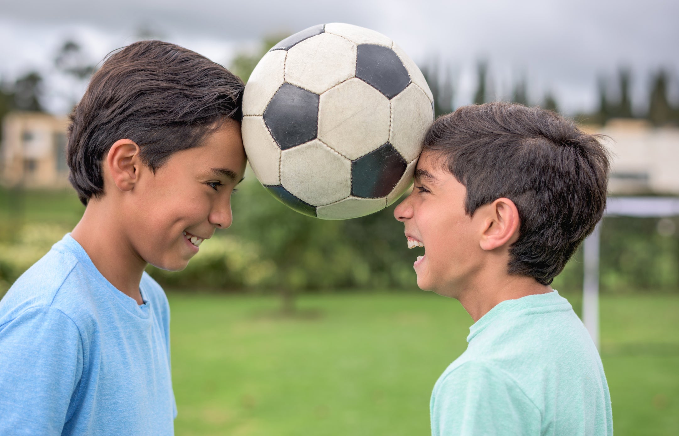 Boys playing football together