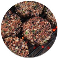 veggie burgers on a grill with hot charcoal under the grill