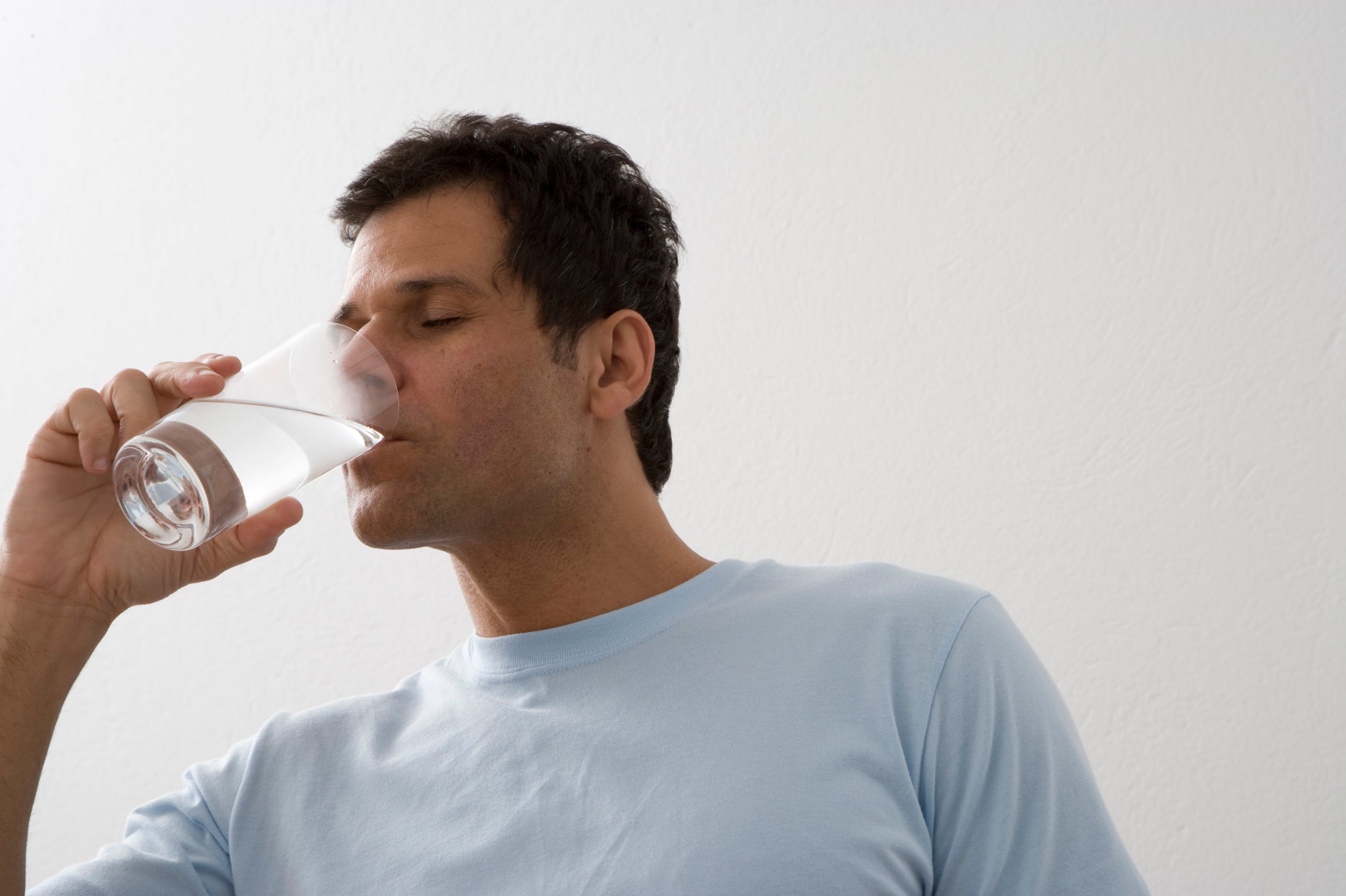 Close-up of a mature man drinking water