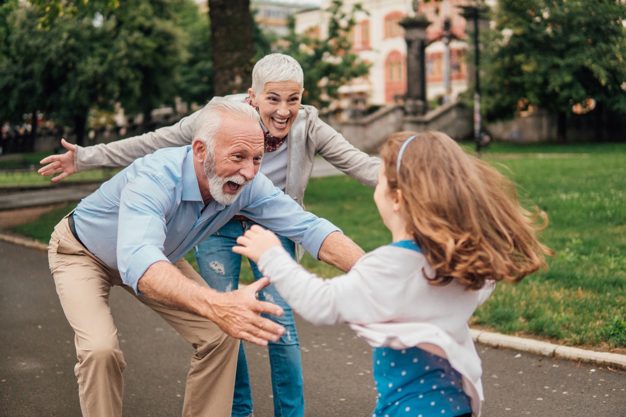 Granddaughter running into arms of her grandparents