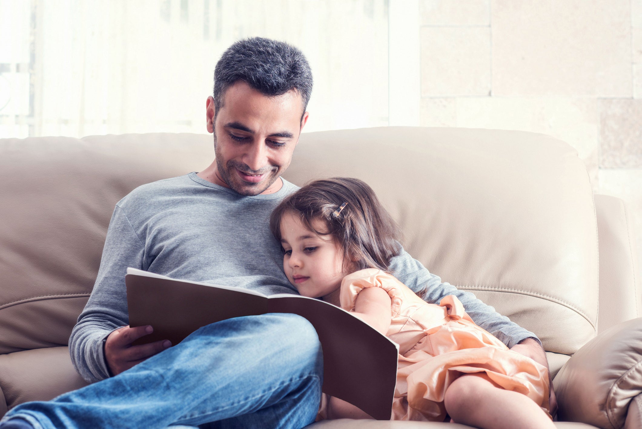 Little Girl And Father Reading Book Together