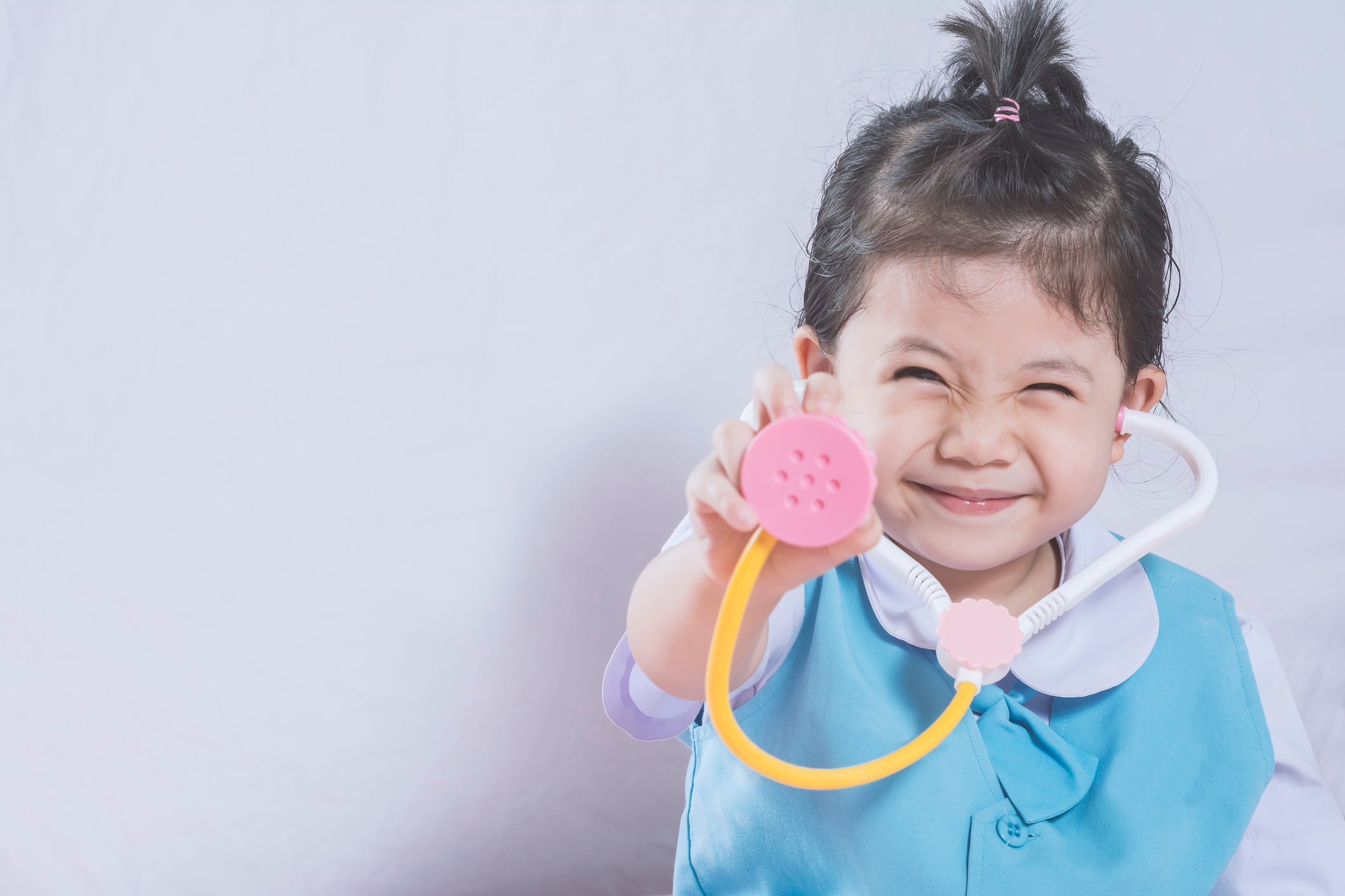 Little Asian Girl and Stethoscope toy with Doctor concept copy space.