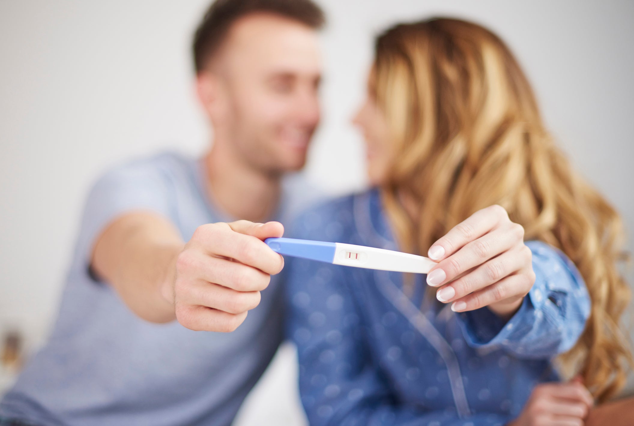 Couple showing positive results of pregnancy test
