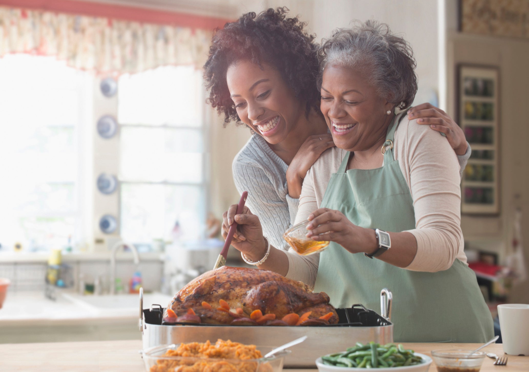 Mother and daughter cooking together in kitchen