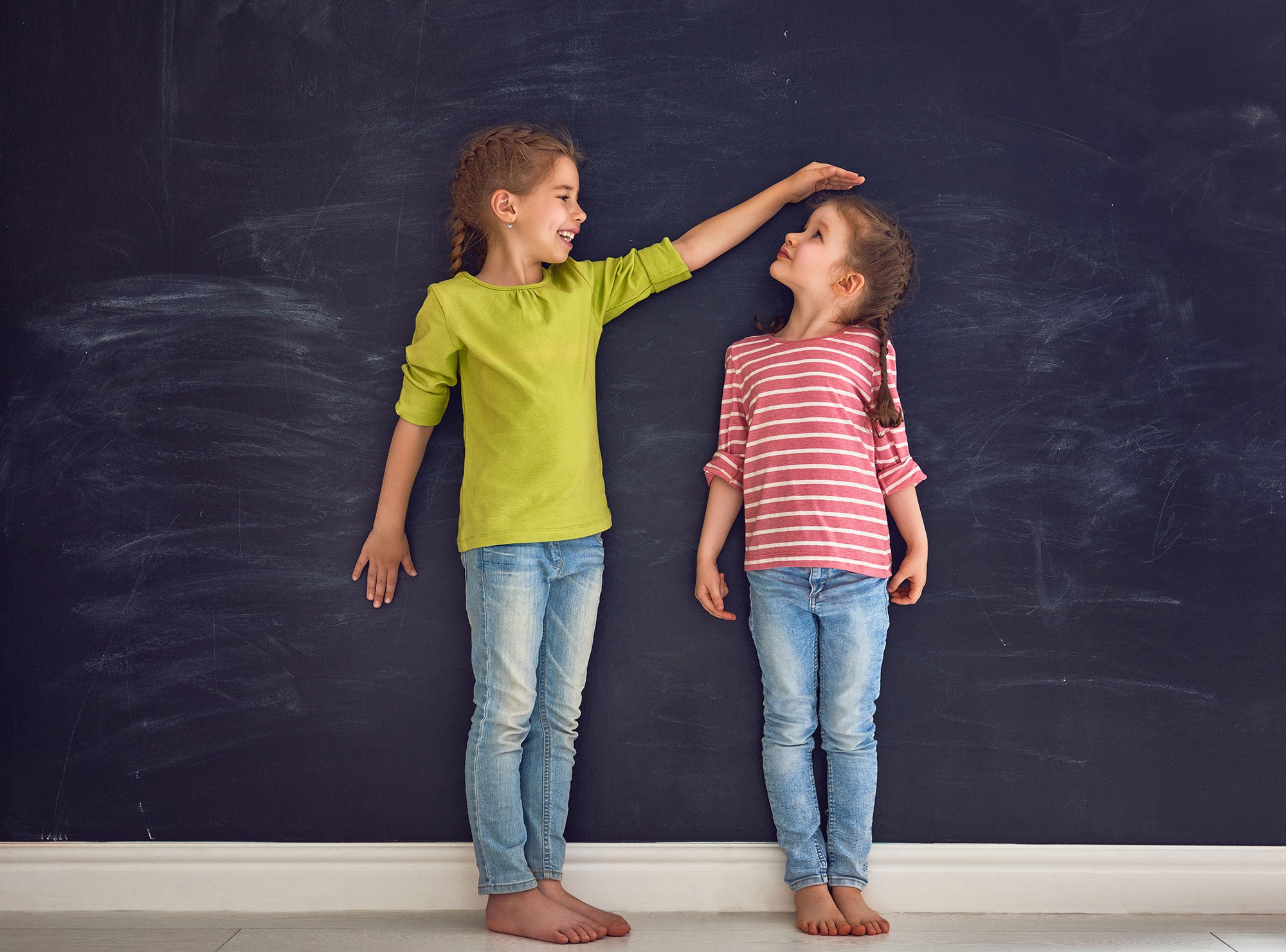 sisters-measuring-height