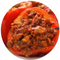 three stuffed bell peppers on a plate