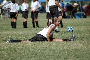 soccer player doing split stretch