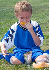 boy eating orange slices