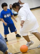 kids playing soccer in gym