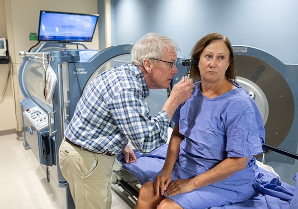 doctor checking patient ear