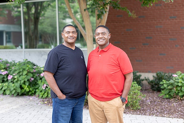 Elton and Shelton with hands in pockets