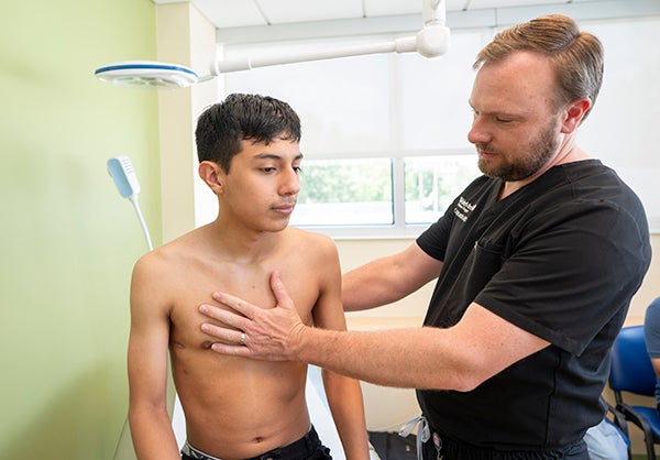 Dr. Muncie examining Joel's chest