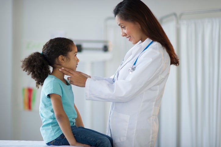 child receiving physical from doctor