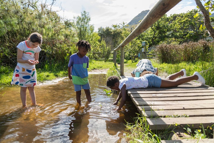 children playing in neighborhood creek