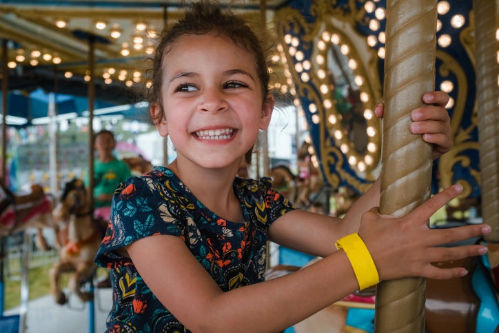 little girl smiling on ride