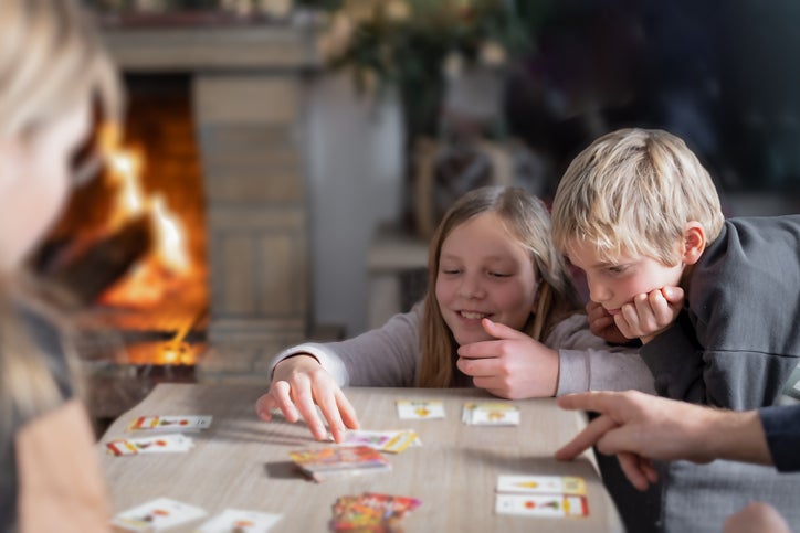 siblings playing a board game