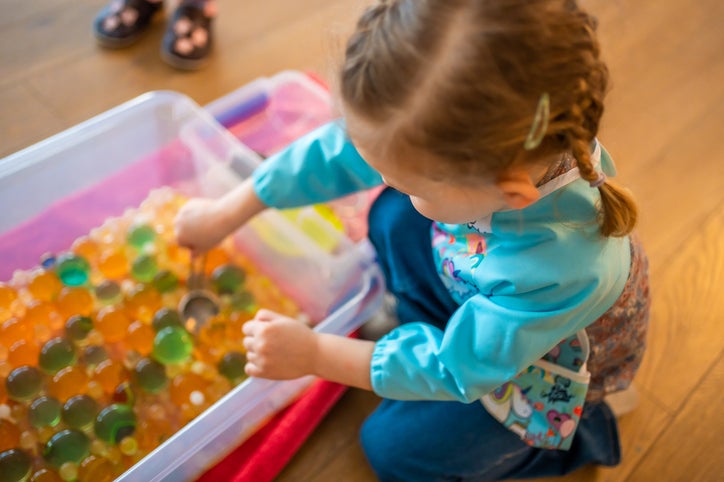 child playing with waterbeads