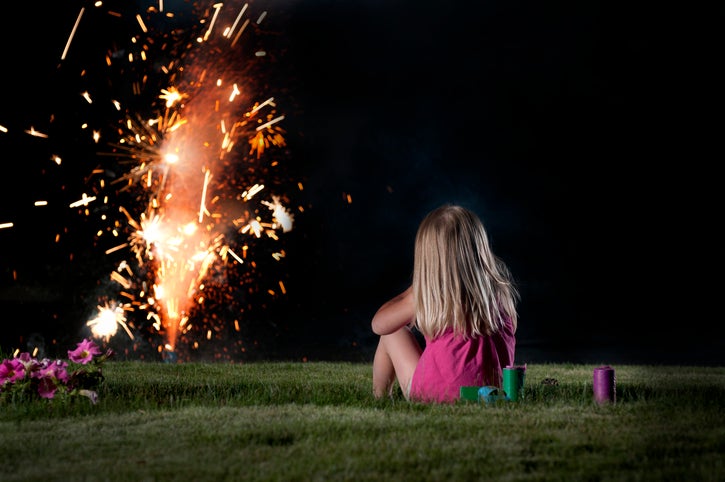 child watching fireworks from safe distance